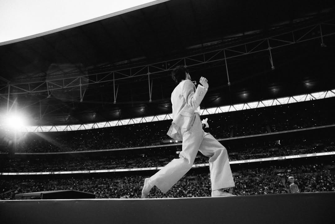 We played Wembly. @connr0 took these photos. It was raining. I took my shoes & socks off. I slipped and fell. 80,000 people went “OOF” all at the same time. 80,000 people also screamed and sung their heads off with big smiles. Ran into some talented friends and made new ones. I hope we get to play this stage again. If not, thank you so much @capitalofficial. Sorry about ‘Be More’ last minute. 🫂 by @stephensanchezofficial